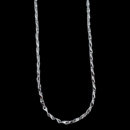 Silver chain necklace on black background
