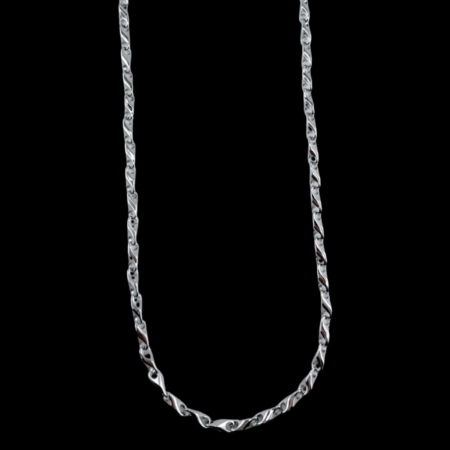 Silver chain necklace on black background