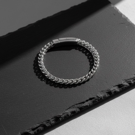 Silver chain bracelet on a black background
