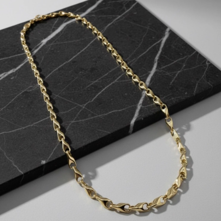 Gold chain necklace on black marble