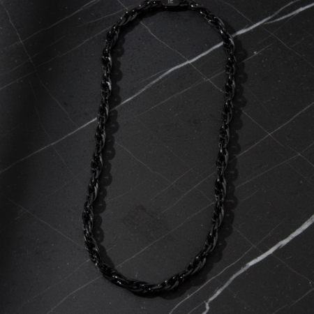 Black chain necklace on a marble surface