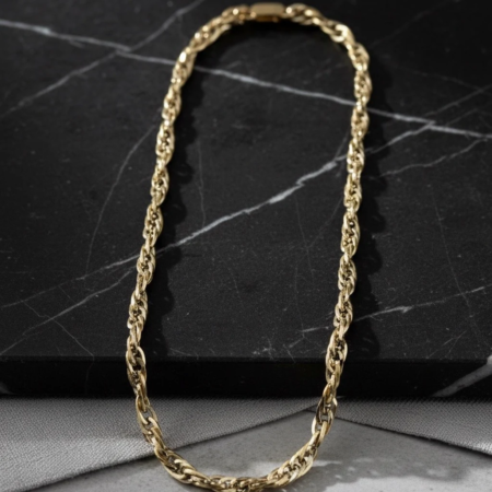 Gold chain necklace on black marble