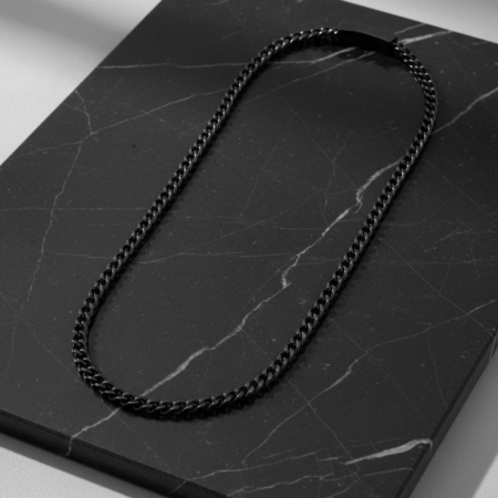 Black chain necklace on marble plate