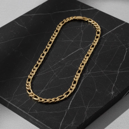 Gold chain necklace on black marble