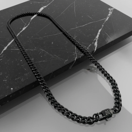 Black chain necklace on black marble
