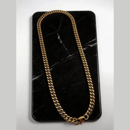 Gold chain necklace on black marble