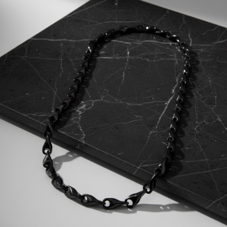Collier chaîne noir sur plaque de marbre